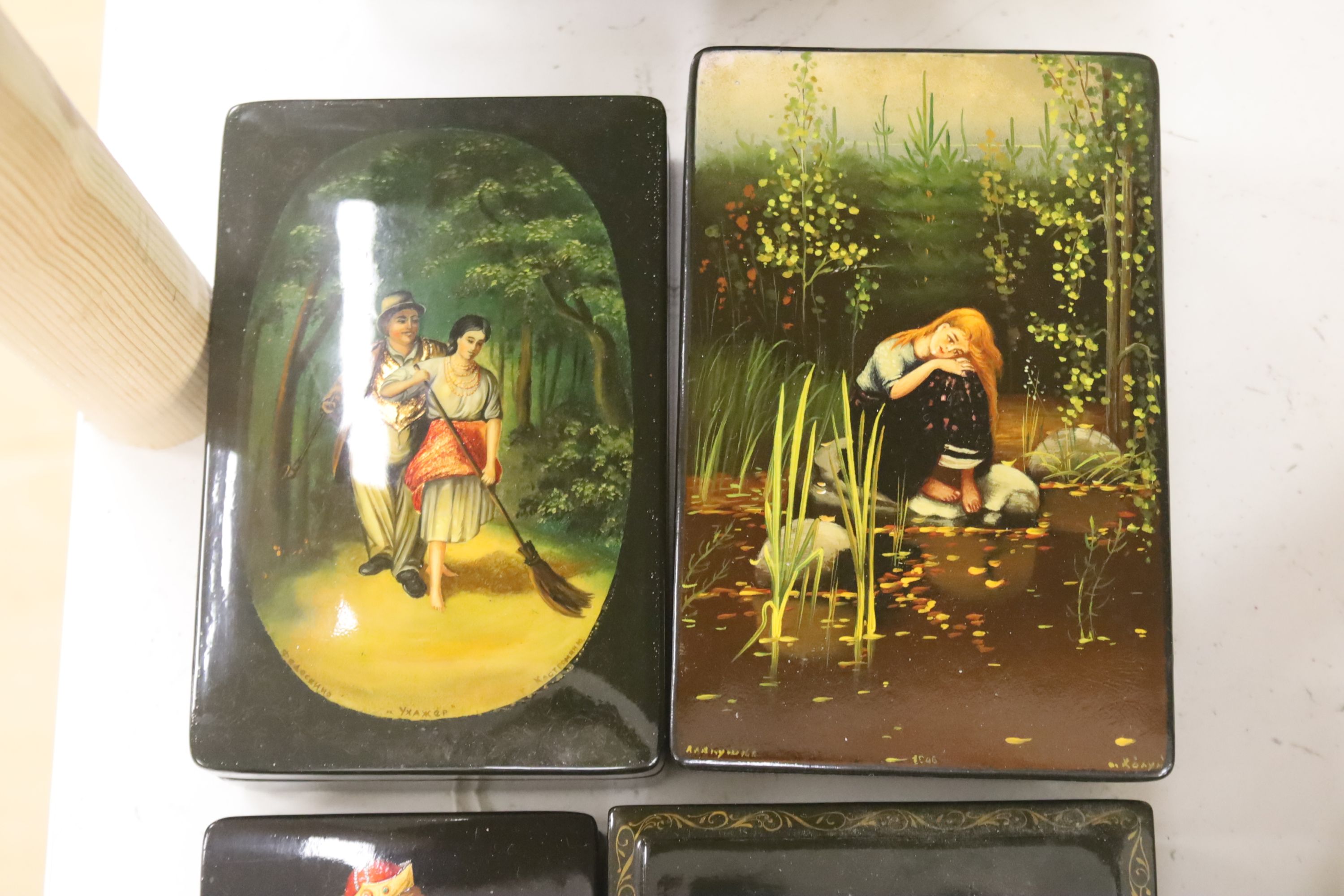 Six Russian painted lacquer boxes, each signed and inscribed, largest 18 x 13cm